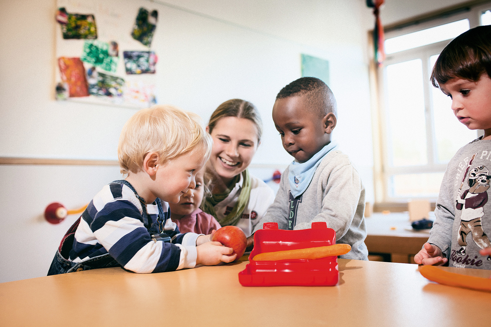 Johanniter-Kindertagesstätten Erzieherin mit drei Kindern