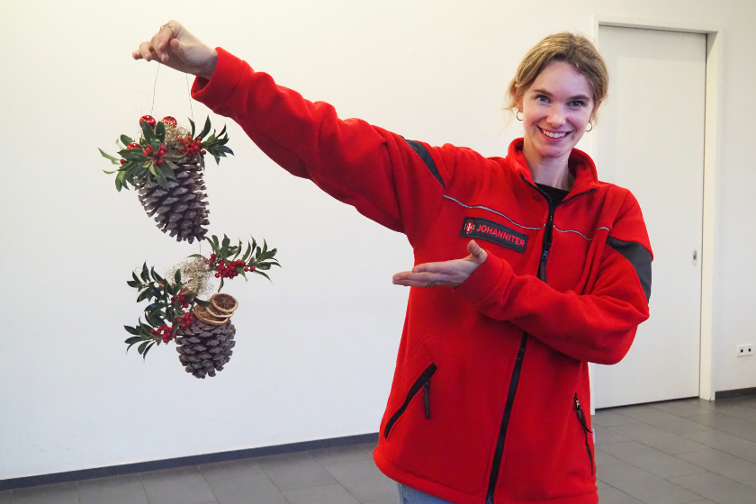 Auch andere individuelle Weihnachtsbasteleien waren möglich. Hier wurden Tannenzapfen an ihrem Kopf mit Tannengrün, Ilex und Engelshaar verziert.