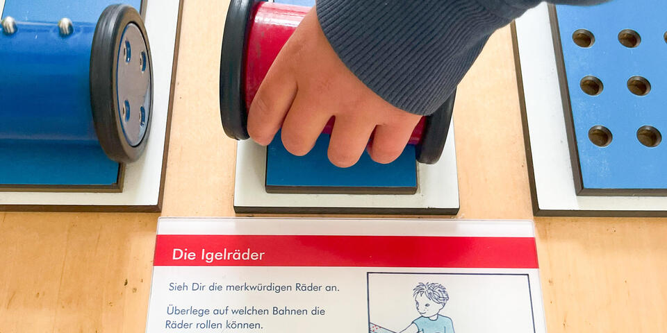 Eine Kinderhand mit einem Gegenstand
