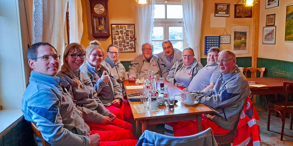 Die Ehrenamtlichen sitzen gemeinsam am Tisch