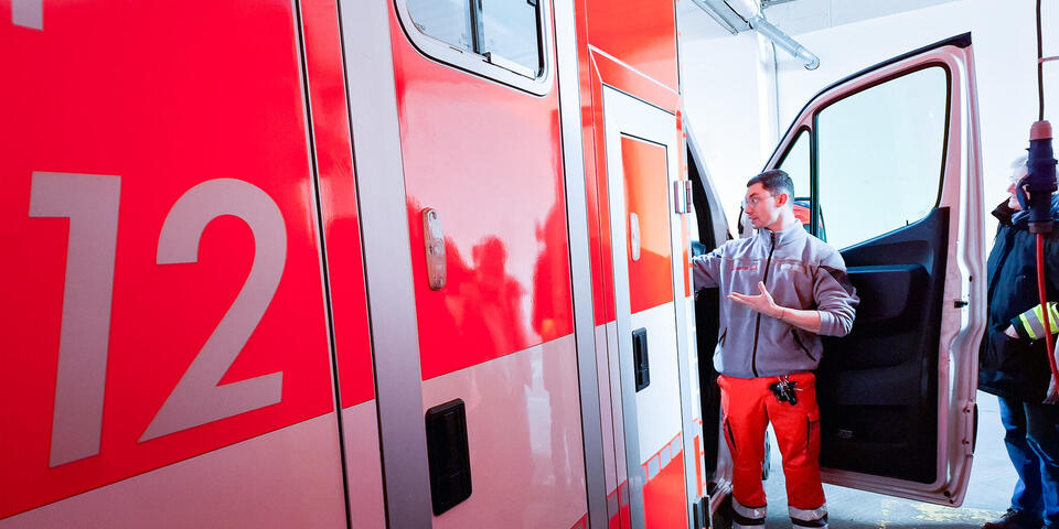 Ein Johanniter an einem RTW mit offener Seitentür