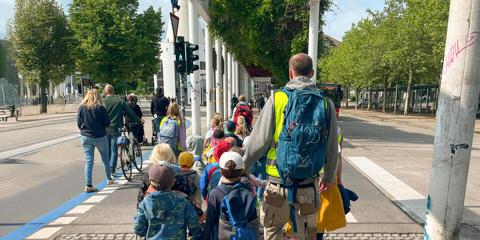 Eine Gruppe von Kindern mit Erwachsenen auf einem öffentlichen Weg