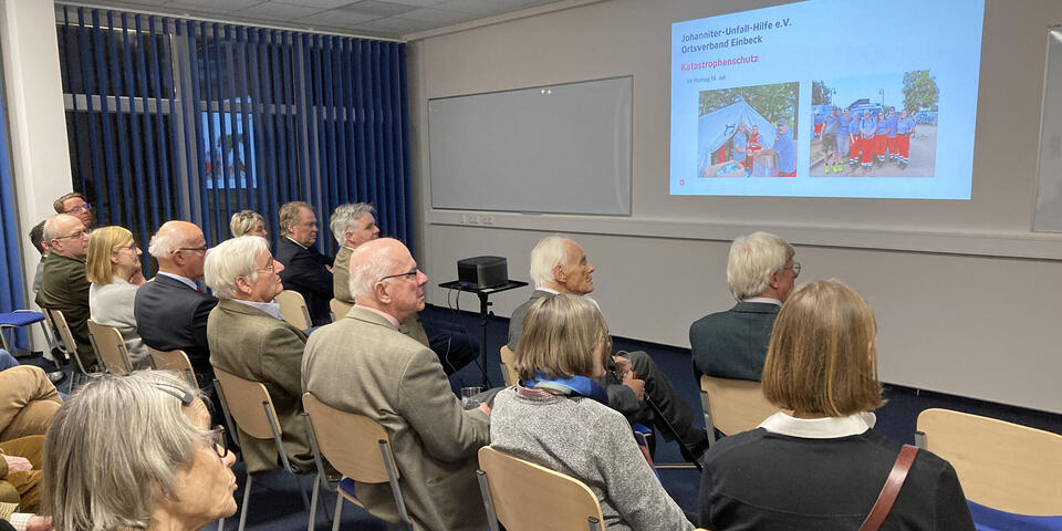 Eine Gruppe von Menschen schauen eine Präsentation an