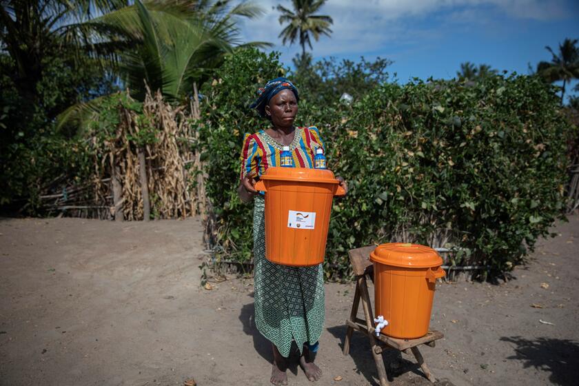 Woman in Mozambique with water buckets