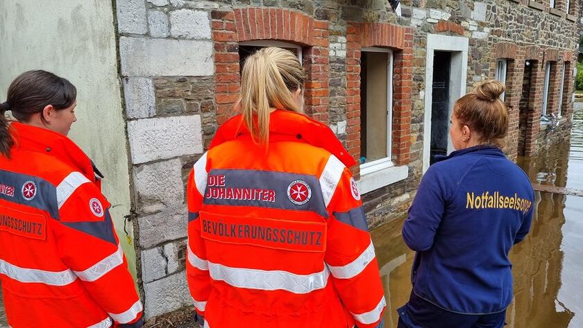 Johanniter-Einsatzkräfte stehen nach der Flut im Schadensgebiet in Stolberg.