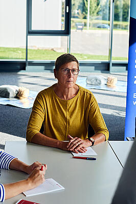 Kursteilnehmende hören Trainerin zu