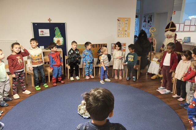 Der Nikolaus las den Kindern aus seinem goldenen Buch vor.