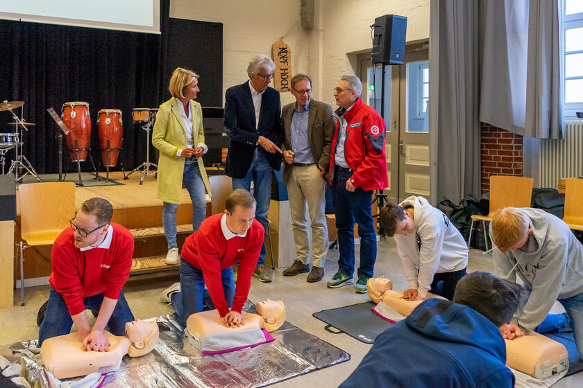 Alexandra Hase-Rodriguez (Rektorin), Michael Haukohl, Dr. Ralf Staiger (Rotary Club) und Hans-Martin Grusnick (Johanniter-Unfall-Hilfe) sind heute beim Herzensretter-Kurs zu Gast in der Mensa der Willy-Brandt-Schule.