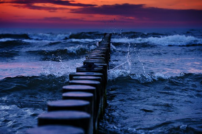 Buhnen im Meer vor einem Sonnenuntergang
