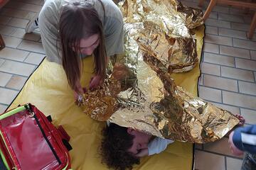 In der Gruppenstunde werden Erste-Hilfe-Maßnahmen wie die Stabile Seitenlage geübt.