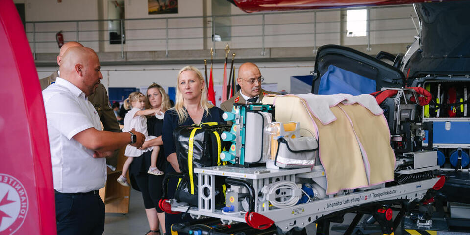 Johannes Jabs, Bereichsleiter Luftrettung JLR erklärt Staatsministerin Stolz Wissenswertes zur Hubschrauber-Ausstattung.