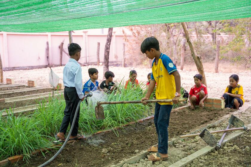 Pupils in Cambodia working in their school garden