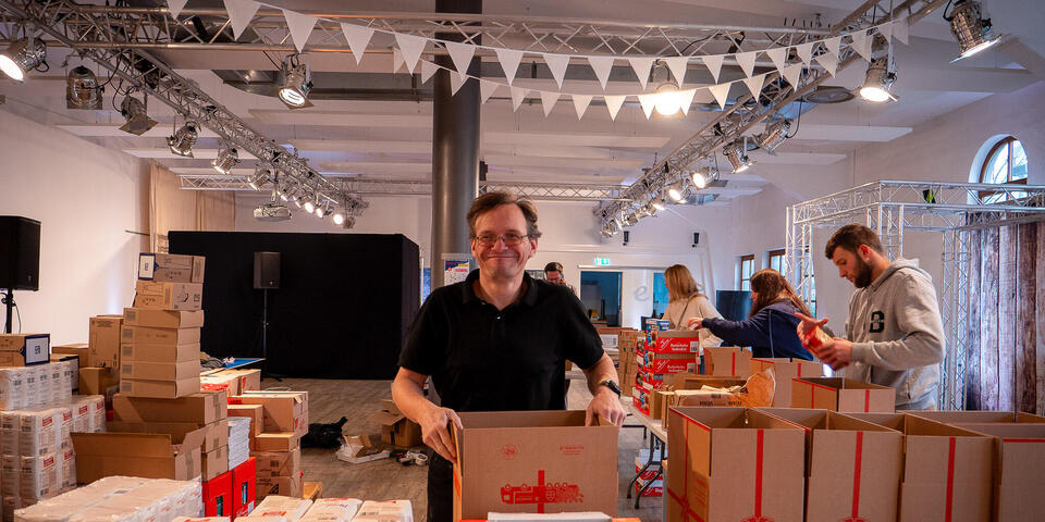 Menschen packen Weihnachtstrucker-Pakete