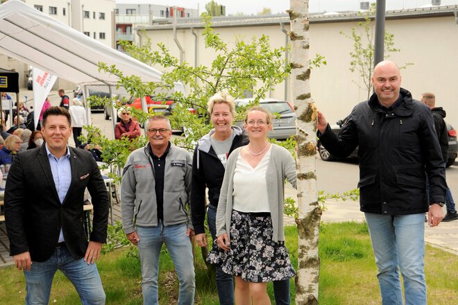 Mitarbeiter der Johanniter, der Wohnen in Northeim, der Kreis-Sparkasse Norheim sowie der Northeimer Bürgermeister stehen neben dem Maibaum. 