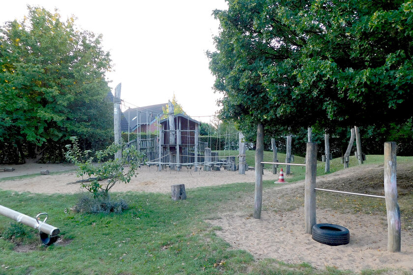 Außengelände der Johanniter-Kindertagesstätte Erkelenz mit Bäumen und Kettergeräten
