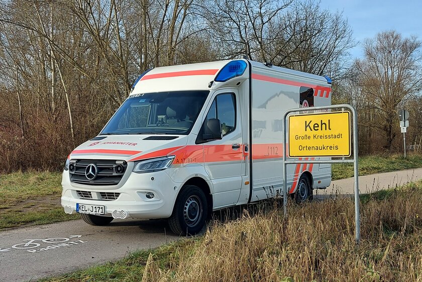Der Johanniter-Rettungswagen nehmen dem Ortsschild der Stadt Kehl.