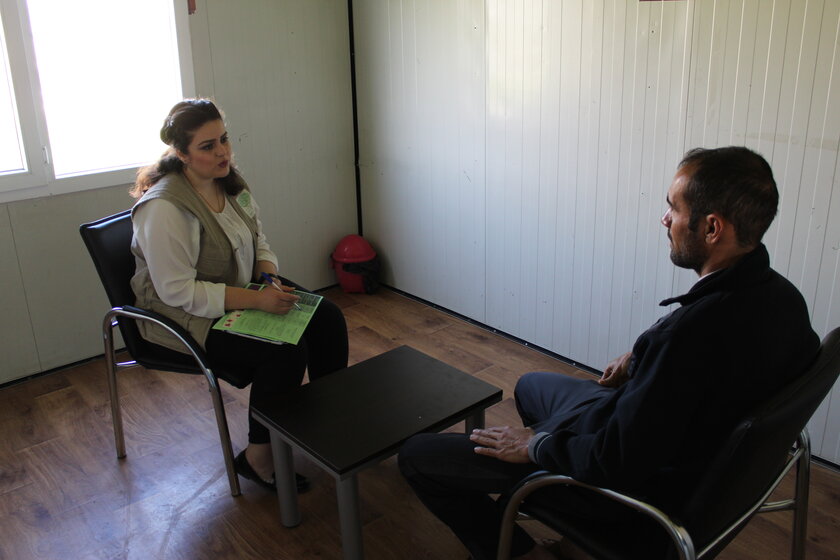 A Jiyan employee speaks to a patient about mental health