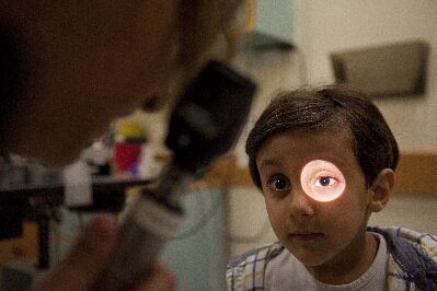 A little boy gets an eye examination