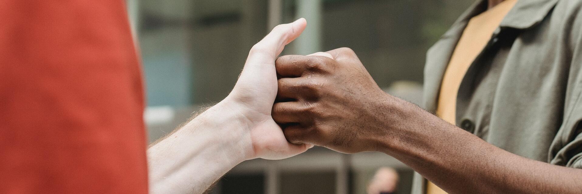 Zwei Menschen geben sich die Hand.