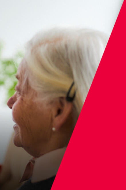 Eine Auszubildende zur Pflegefachfrau unterhält sich mit einer Seniorin.
